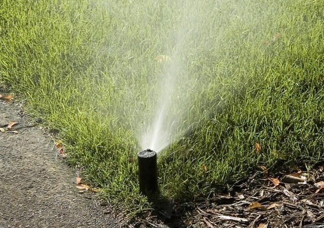 Automatic Sprinkler Misting Corner Of Green Lawn 558417 Edited